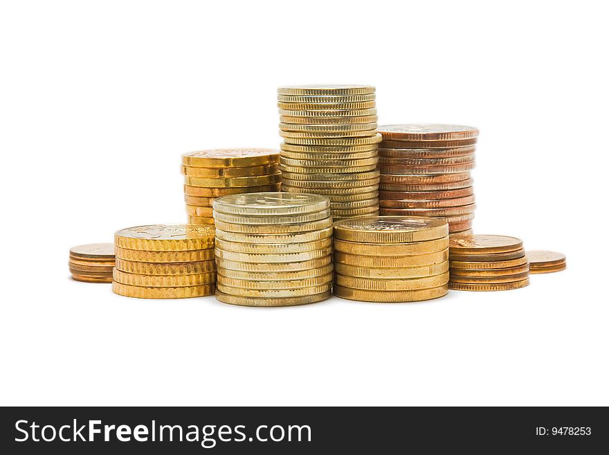 Several piles of coins isolated on white