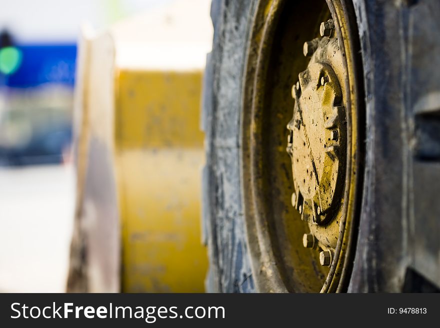 Closeup photo of roadwork machinery. Selective focus on wheel. Closeup photo of roadwork machinery. Selective focus on wheel.