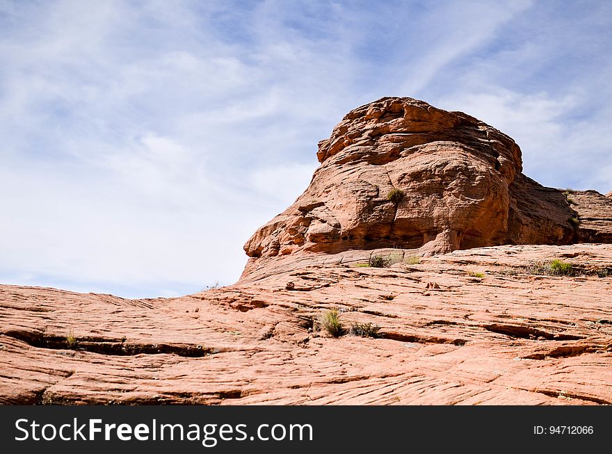 Sandstone rock crag against blue skies on sunny day. Sandstone rock crag against blue skies on sunny day.