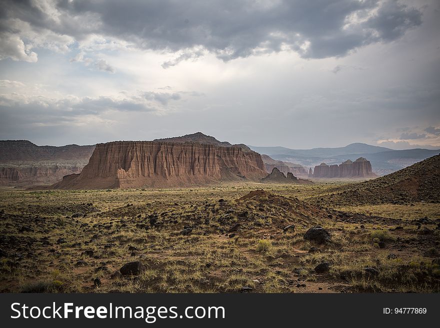 Scenic View of Desert Landscape Against Dramatic Sky