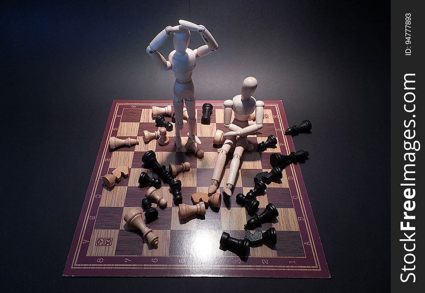 Wood Puppets On Chessboard