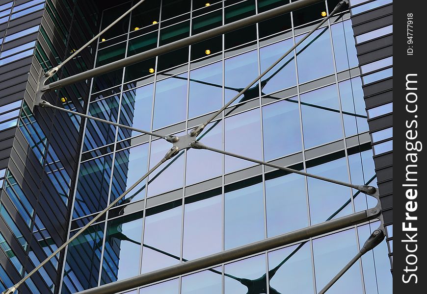 Facade of glass and steel modern building on sunny day.