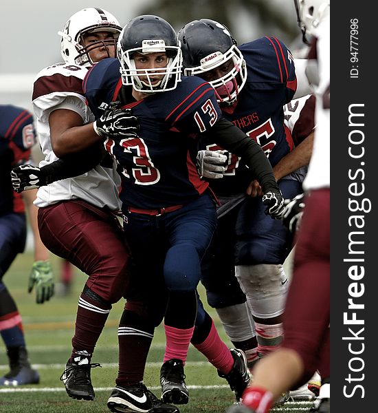 Football players on field during game. Football players on field during game.