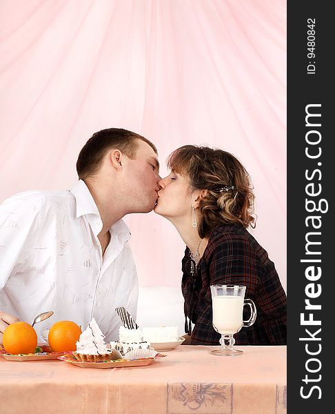 Young couple in love feeding each other with cake