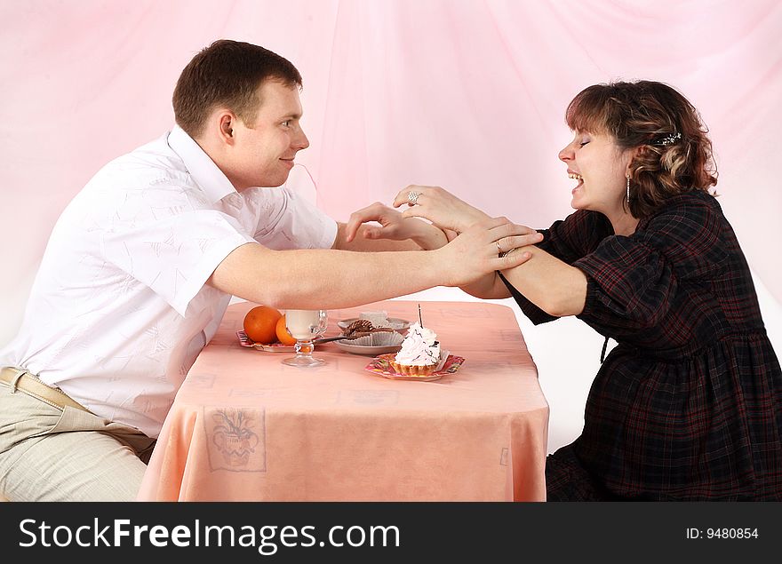 Young couple in love feeding each other with cake