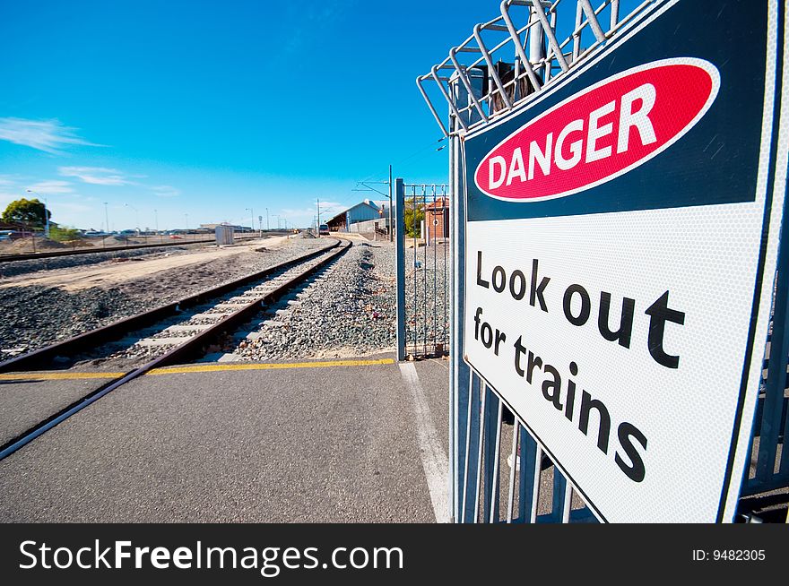 A danger sign along a railway warning pedestrains of oncoming trains. A danger sign along a railway warning pedestrains of oncoming trains.