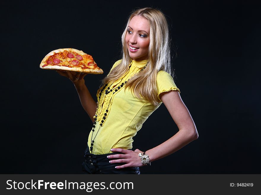 A beautiful young woman eating pizza