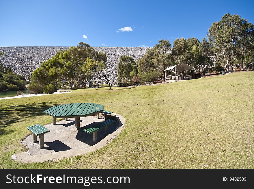 A widespread picnic area in a park, complete with barbeque facilities and a huge grass patch for children to run about and play. A widespread picnic area in a park, complete with barbeque facilities and a huge grass patch for children to run about and play.