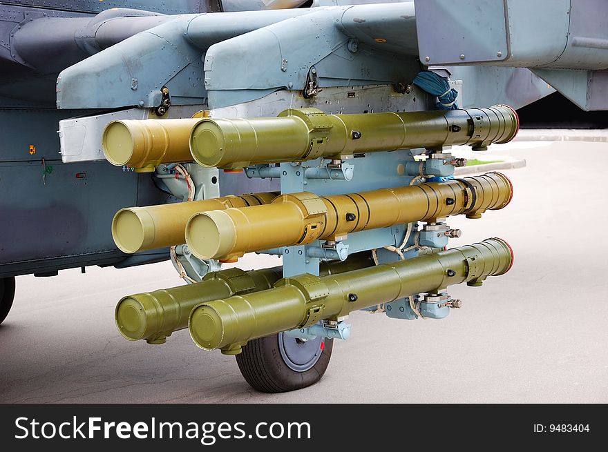 Rockets placed under a military plane wing. Rockets placed under a military plane wing