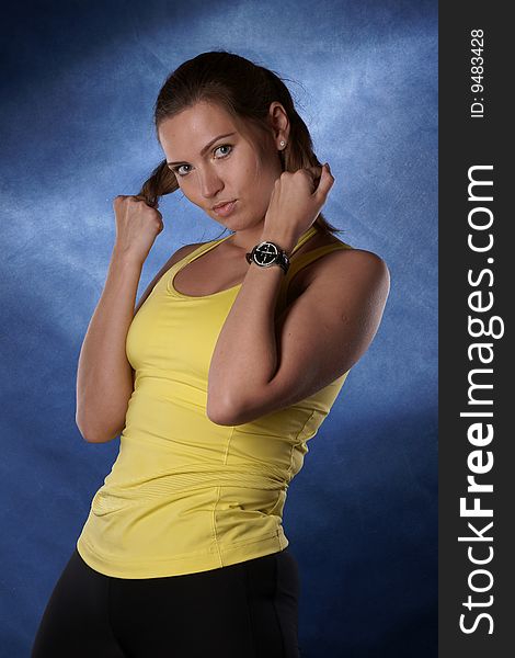 The sports girl is photographed on a dark blue background