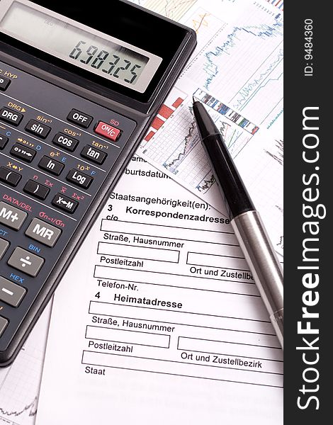 Financial statement with calculator and pen. Financial statement with calculator and pen
