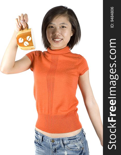 Charming Asian girl holding big mug with tea. Girl with kind face expression, wearing orange sweater. Charming Asian girl holding big mug with tea. Girl with kind face expression, wearing orange sweater.