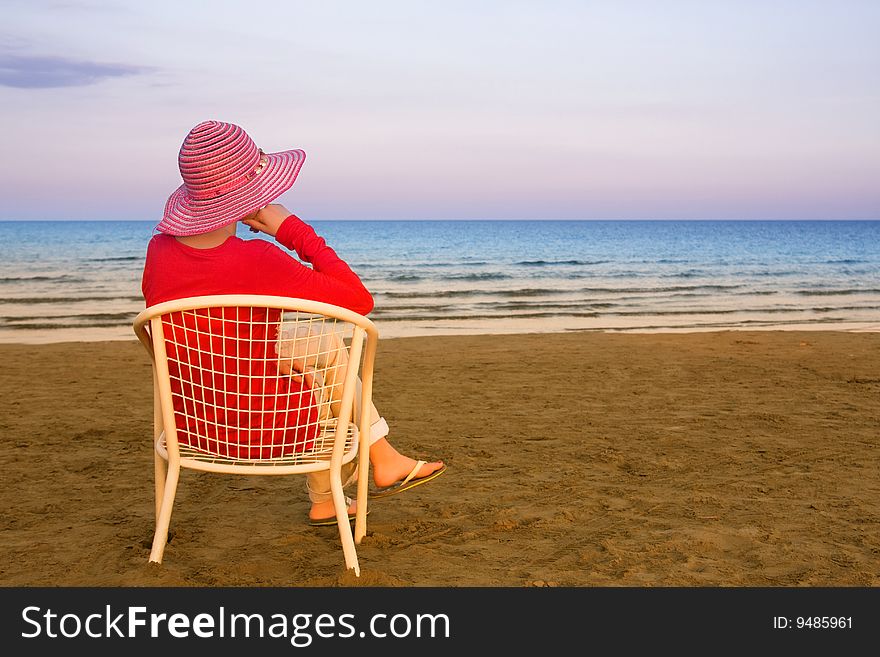 Lonely young woman near the ocean