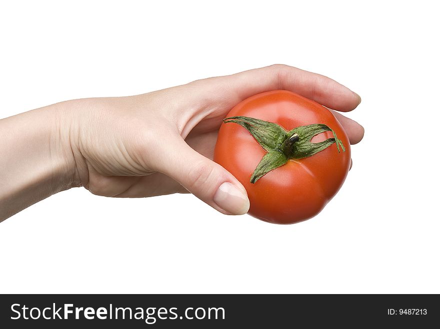 Ripe tomato in a female hand isolated on white background