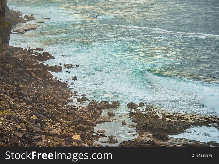 A rocky sea coast with waves coming ashore. A rocky sea coast with waves coming ashore.