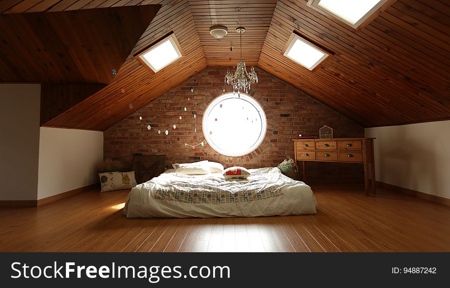 A loft bedroom with skylights.