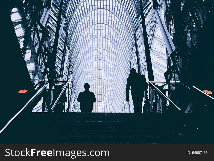 Silhouette of people on stairs in modern airport building. Silhouette of people on stairs in modern airport building.