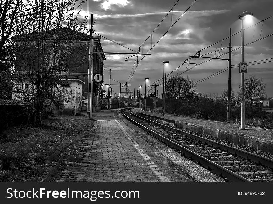Railroad Tracks by Bare Trees Against Sky