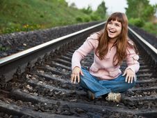 The Young Beautiful  Girl Sits On Railway Stock Photography