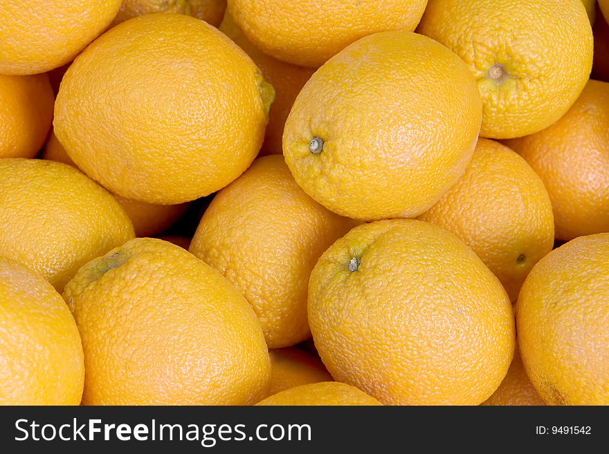 View in close up of some oranges for sale in a market.