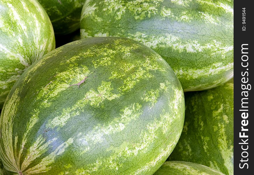 Close up on some watermelons on a market's table.