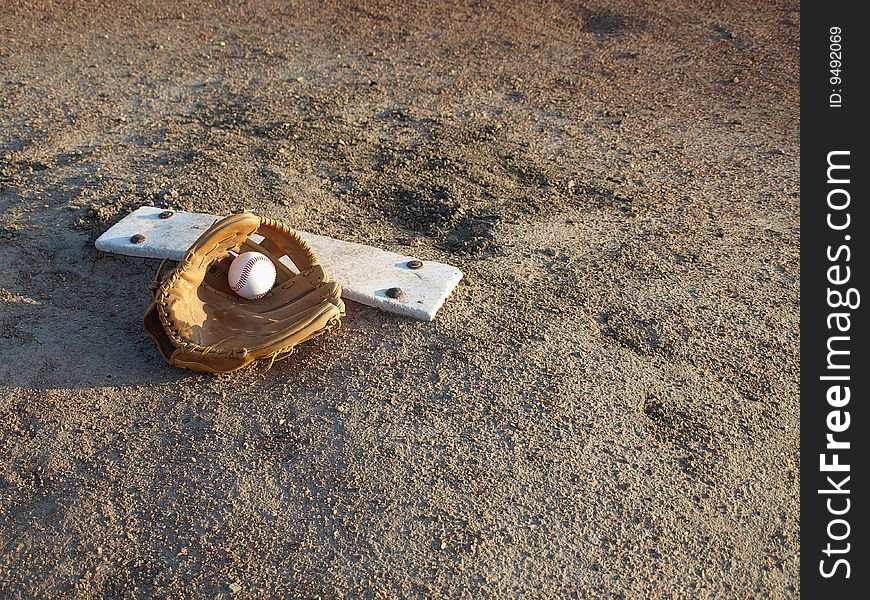 The pitchers mount with ball and glove waiting for the big game. The pitchers mount with ball and glove waiting for the big game.