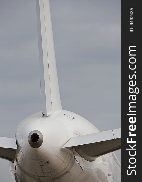 Back of a white  airplane  vertical with copy space