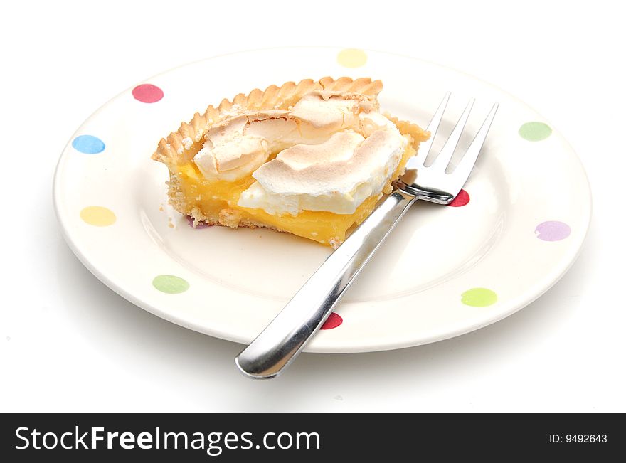 Close up shot of a fork and lemon meringue pie