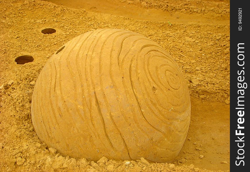 Ball from sand with an uneven surface, representing a planet