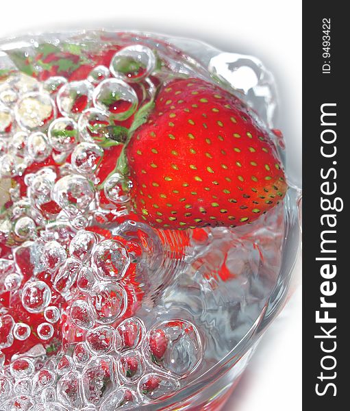 A fresh strawberry in water bubbles. A fresh strawberry in water bubbles