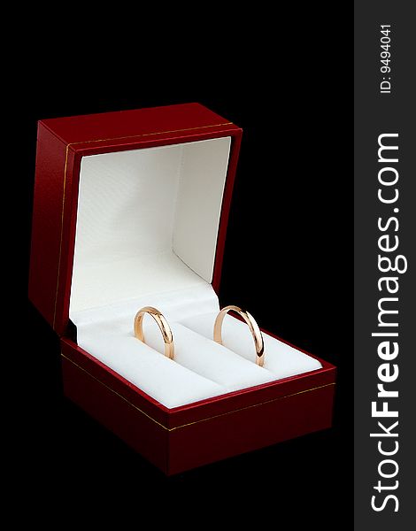 Wedding rings in a red box  on a black background