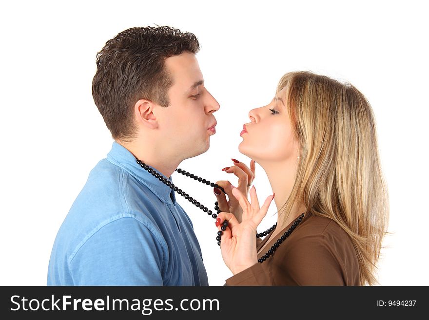 Young pair kisses, woman draws man for beads