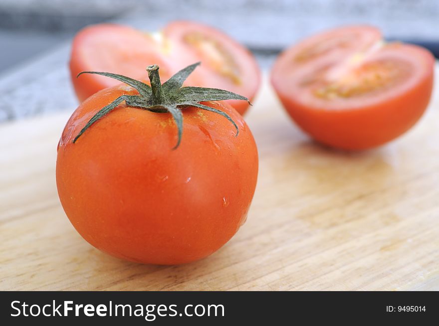 One Tomatoe on wood background. One Tomatoe on wood background