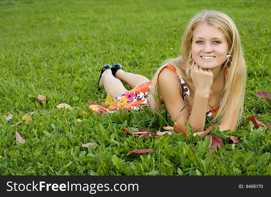 Young Woman Lying On A Green Grass