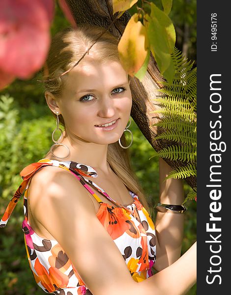 Attractive blond caucasian woman in summer park