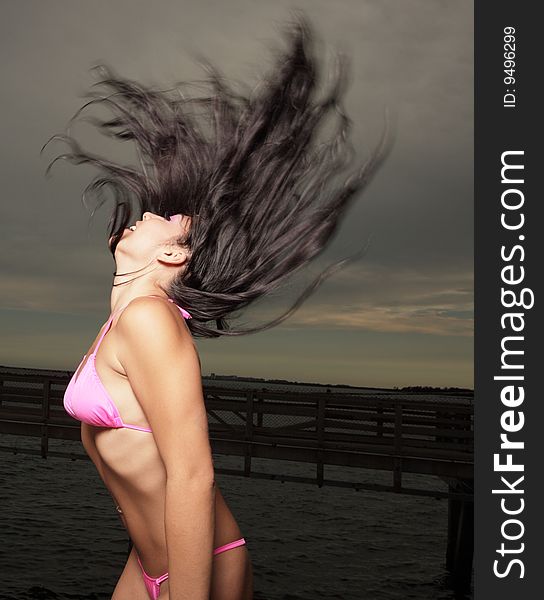 Beautiful young woman flicking her hair