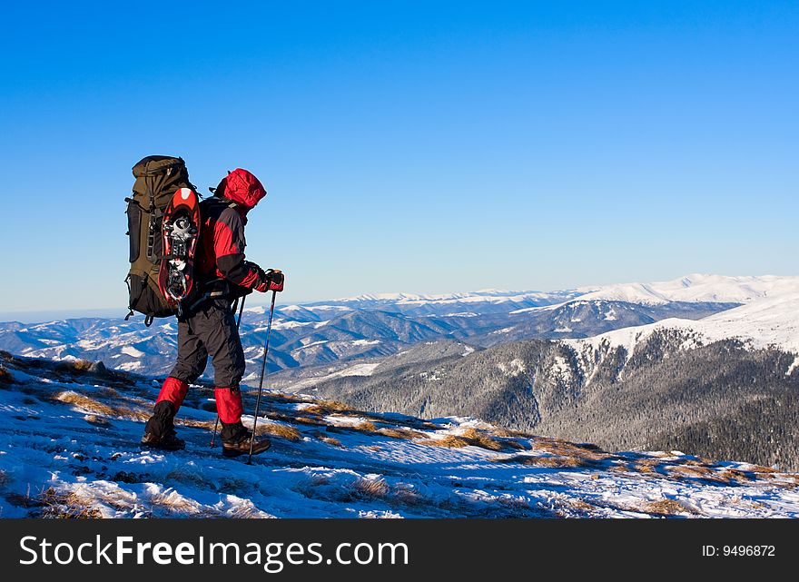 Hikers are in winter in mountains