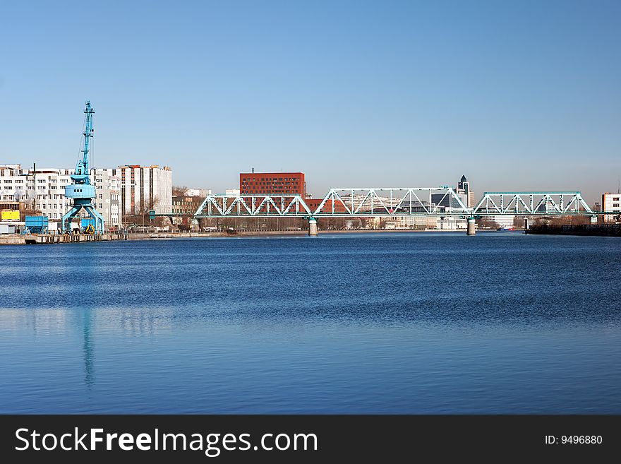 Blue river with railroad bridge city landscape. Blue river with railroad bridge city landscape