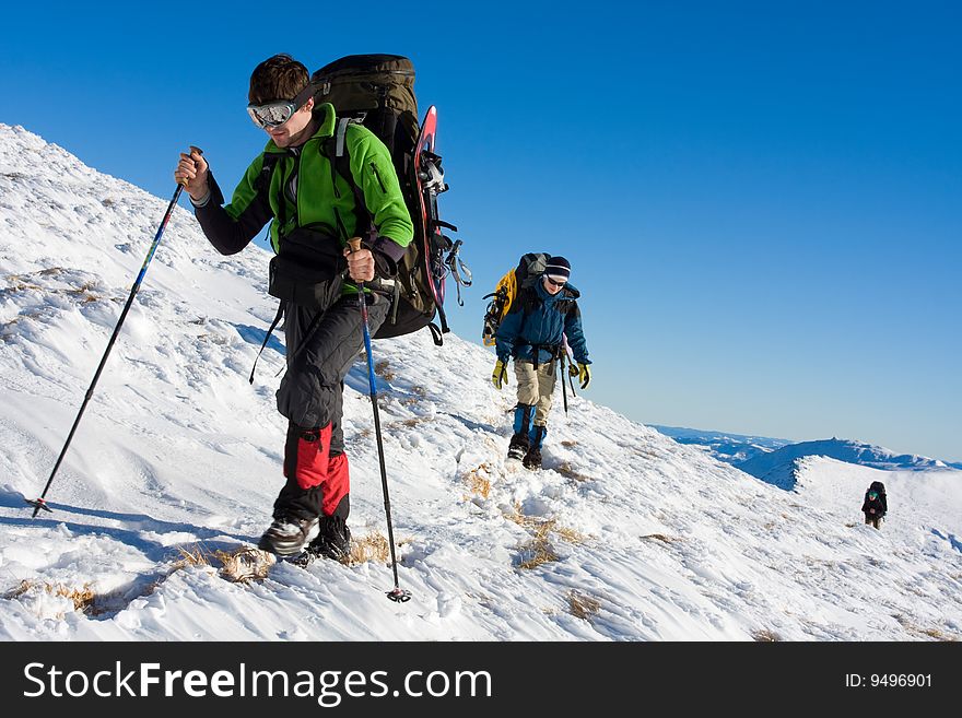 Hikers are in winter in mountains