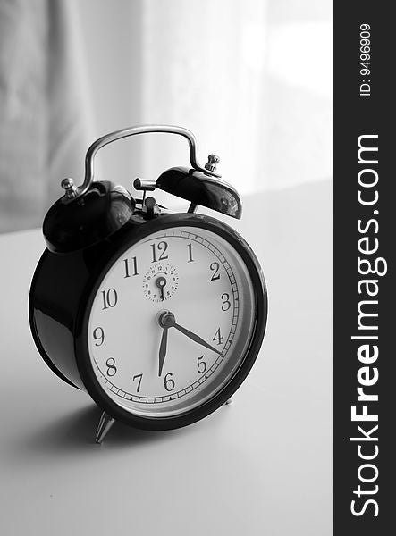 An alarm clock shot in black and white. An alarm clock shot in black and white
