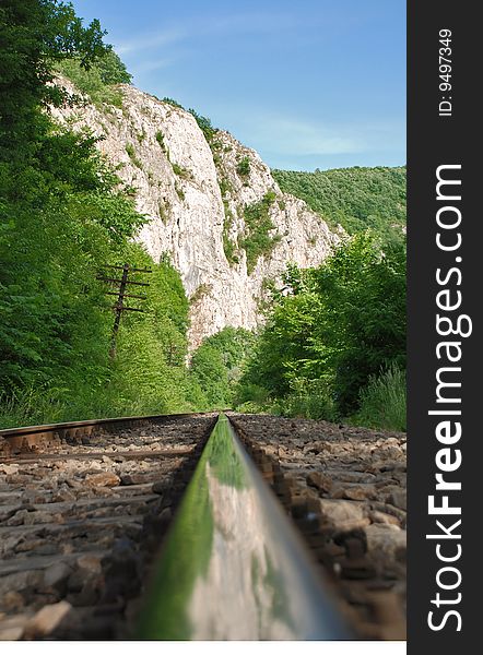 Landscape with  railway in the mountains- mountain and sky reflected in the  railway track