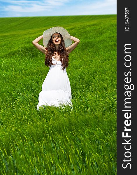 Girl in a green field laughing and enjoying nature. Girl in a green field laughing and enjoying nature