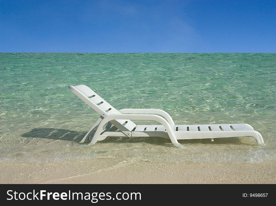 A white plastic chair photographed at the sea. A white plastic chair photographed at the sea.
