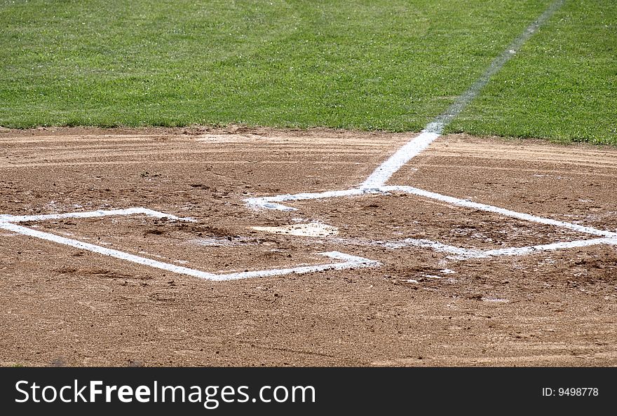 A closeup view of home plate on a baseball field