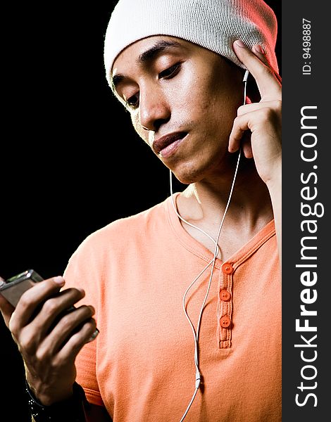 A handsome asian male listening to music