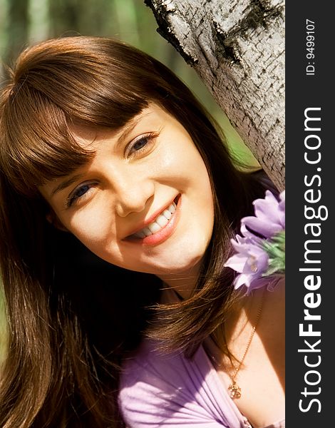 Young adult woman in a birch wood with snowdrops. Young adult woman in a birch wood with snowdrops