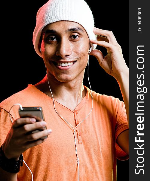 A handsome asian male listening to music