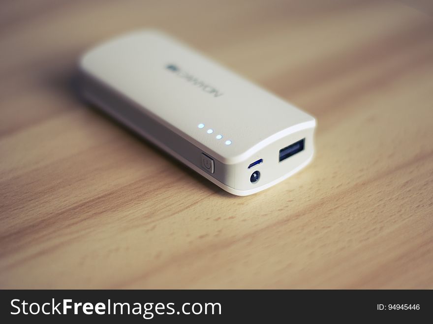 A portable power bank on a wooden background.