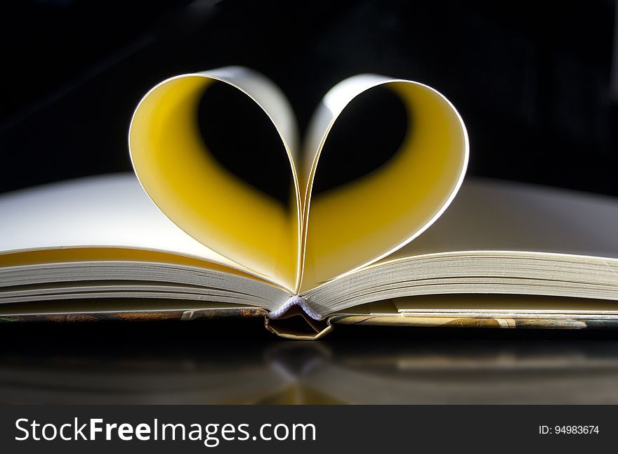Pages of open book folded into heart shape. Pages of open book folded into heart shape.
