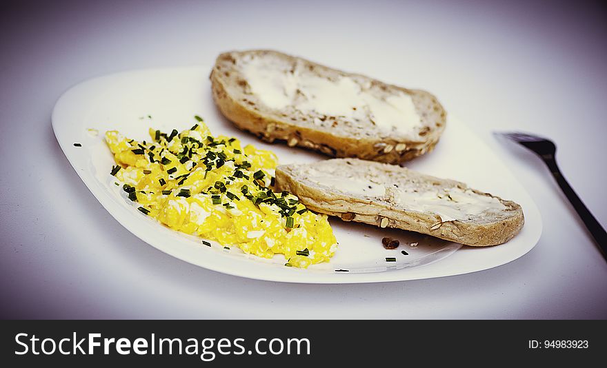 A plate with omelet and pieces of buttered bread. A plate with omelet and pieces of buttered bread.